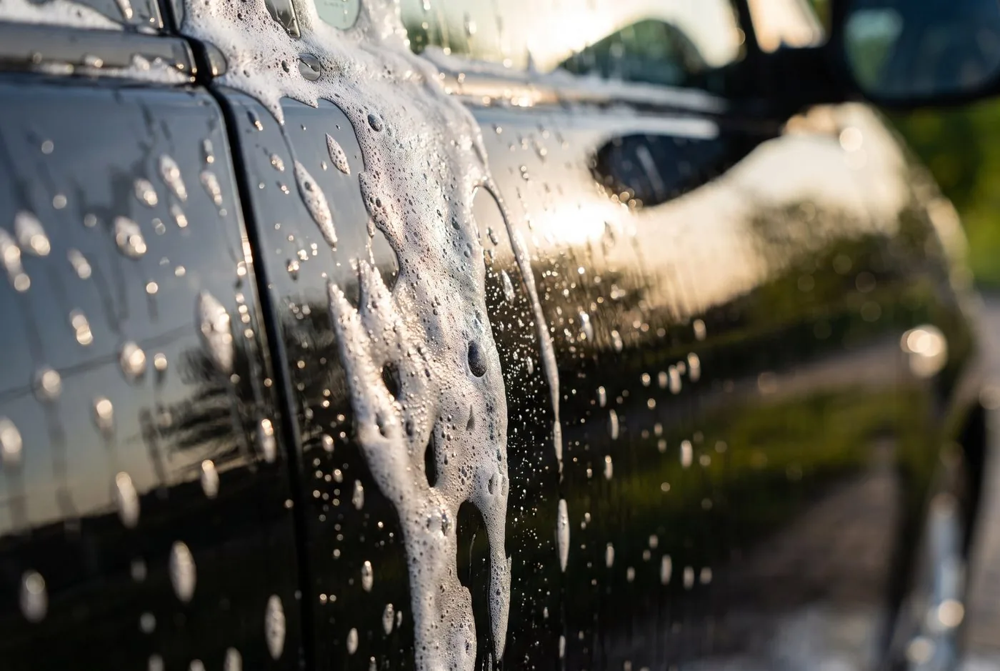 Foam wash on a vehicle panel, illustrating gentle preparation rather than a verified matte-finish result