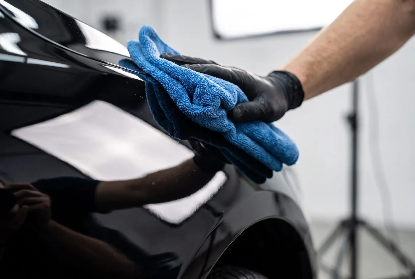 Microfiber towel buffing polished paint to a high-gloss finish